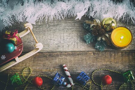 Christmas sleigh, gift boxes, Christmas toys on an old wooden surface, top view, texture, space text, retro styleの写真素材