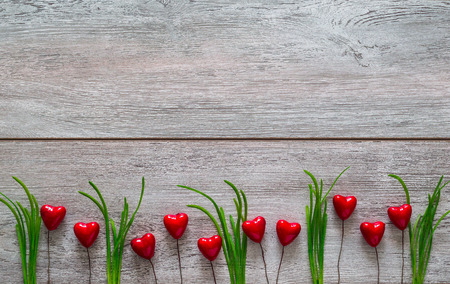 Valentines Day wooden surface background with hearts and a gift, place for text, top viewの写真素材