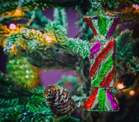 Closeup of Christmas toy hanging from a decorated Christmas tree, retro filter effect.の写真素材