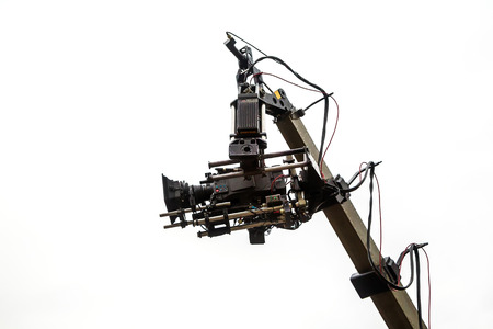 Professional video camera on the crane on a white background. technology. space for textの写真素材