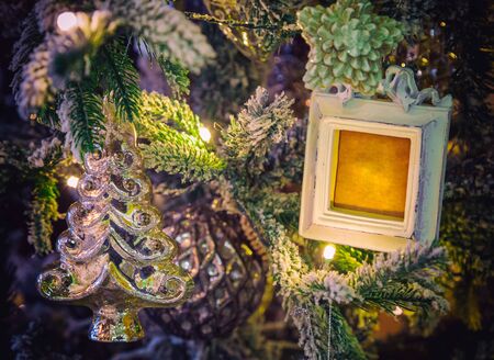 Closeup of Christmas toy hanging from a decorated Christmas tree, retro filter effect.の写真素材