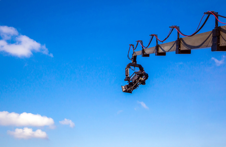 Professional camcorder on a crane against a blue sky. technology. space for textの写真素材