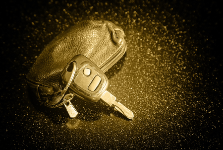 Car keys and remote security alarm on a black desk. Top view with plenty of space for copy, retro style, toningの写真素材