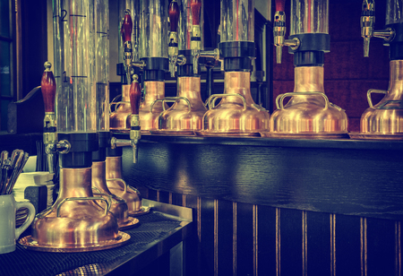 A mixer and a glass tube for draft beer in a modern bar. beer dispenser, close-up, selective focus,...