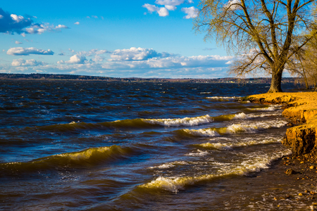 Landscape of the lake in a bright sunny spring day. Blue sky with white clouds over a large lake. panoramaの写真素材