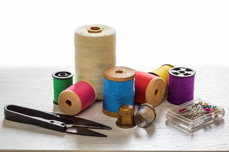 Sewing tools and accessories for sewing colored threads, coils, scissors, buttons, needles, pin and...