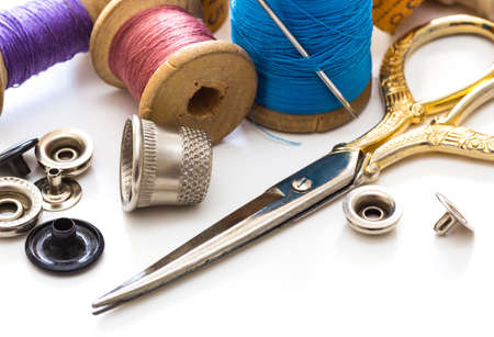 Sewing supplies and hand sewing tools. Sewing accessories for sewing, thread, scissors, on a white...