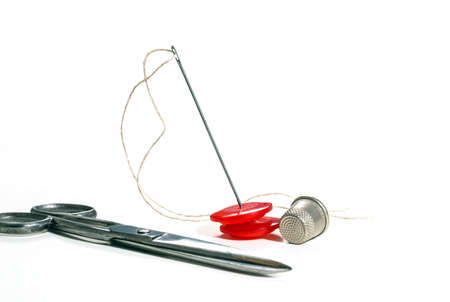 Creative image. Old sewing accessories for sewing handmade on a white background, a needle and...