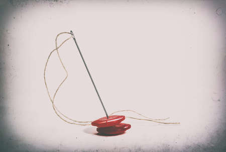 Creative image. Old sewing accessories for sewing handmade on a white background, a needle and thread, a set for needlework. Retro style. Place for your text.の写真素材