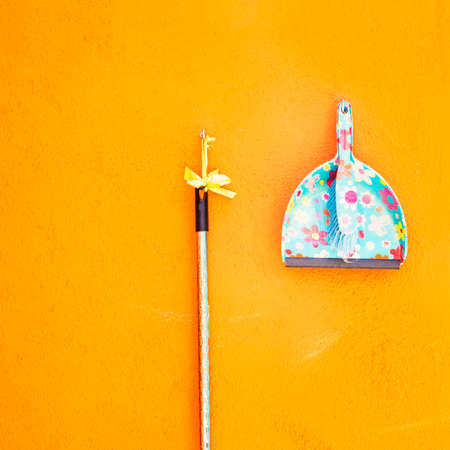 Abstract orange wall and cleaning utensilの写真素材