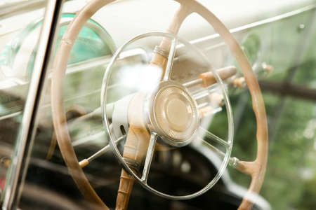 Retro car steering wheel through the glassの写真素材