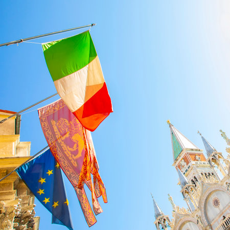 Italian and Venetian flags on Venice street, Italyのeditorial素材