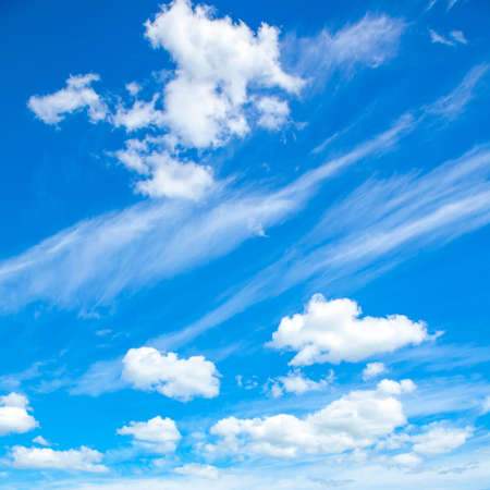 Blue sky and puffy clouds natural backgroundの写真素材