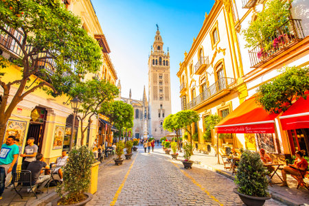 SEVILLA, SPAIN - 20 April 2020: Sunny Seville street and Giralda towerのeditorial素材