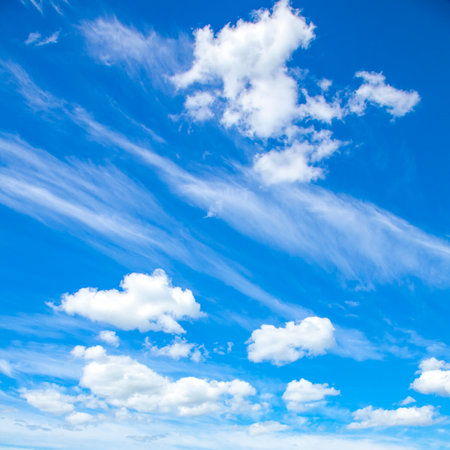 Blue sky and white fluffy clouds natural backgroundの写真素材