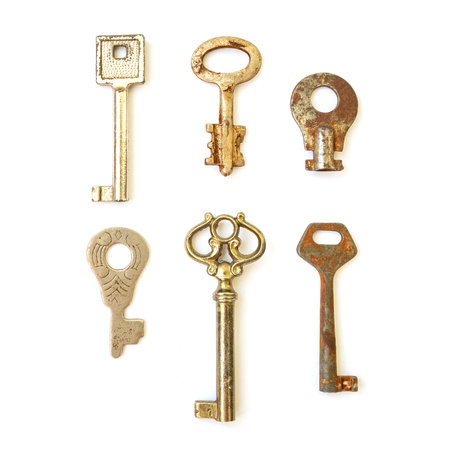 Old vintage keys collection isolated on white backgroundの写真素材