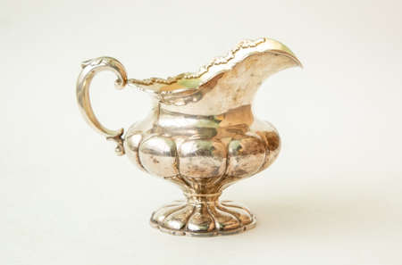 Antique silver jug on white backgroundの写真素材