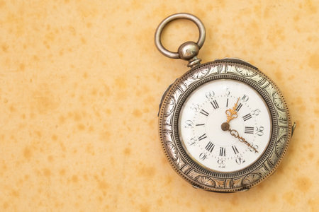 Old silver pocket watch on sepia background, copy space for textの写真素材
