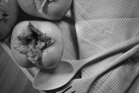 persimmons on wooden table focus on one pointの写真素材