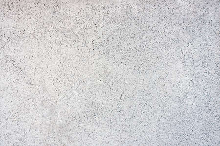 White wall in speckles background, texture
