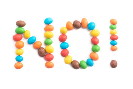 Word no, of multicolored candies isolated on white background for any purposeの写真素材