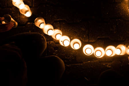 Burning candles in cups, in the dark, for any purposeの写真素材