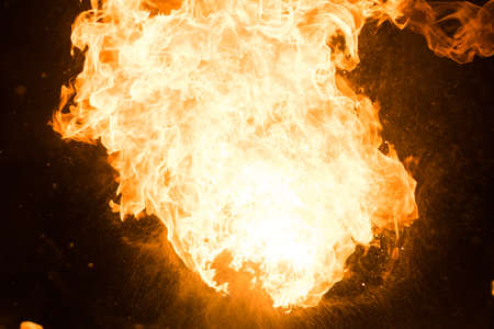 Bright flash of fire, against the black sky, for any purposeの写真素材