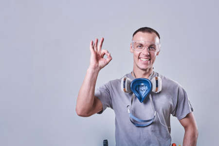 Master Builder-finisher in working clothes, shows the sign OK for any purposeの写真素材