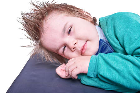 Little boy lying with his hands under his head, isolated on white background, for any purposeの写真素材