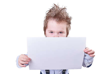 The little boy holds in hand a blank sheet of paper isolated on white background for any purposeの写真素材