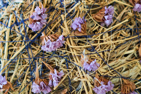 Straw and dried flowers, background, texture, for any purposeの写真素材