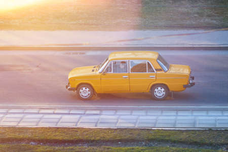 Old Soviet car in sunset rays for any purpose
