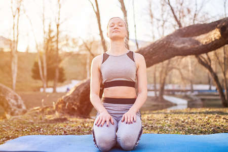 Girl on yoga Mat in the Park for any purpose