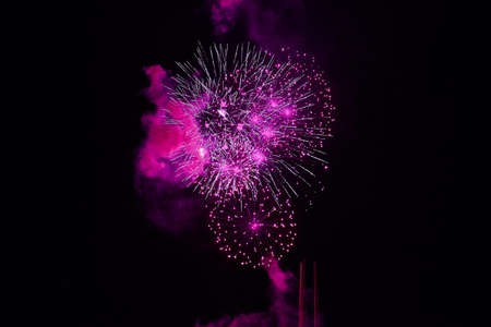 Inexpensive fireworks, over the city, pink.   For any purpose