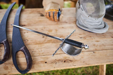 Medieval weapons on a wooden table for any purposeの写真素材