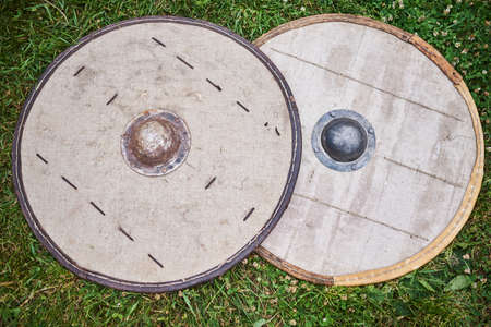 Two barbarian shields on the ground for any purposeの写真素材
