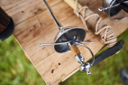 Medieval weapons on a wooden table for any purposeの写真素材