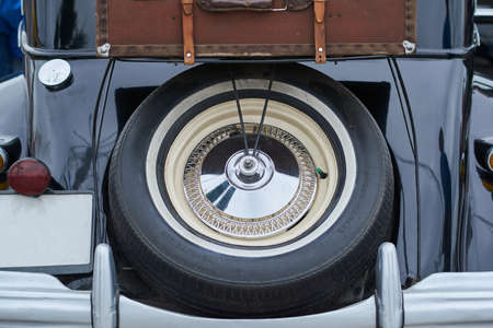 Wheel and suitcase on the trunk of an old car for any purposeの写真素材
