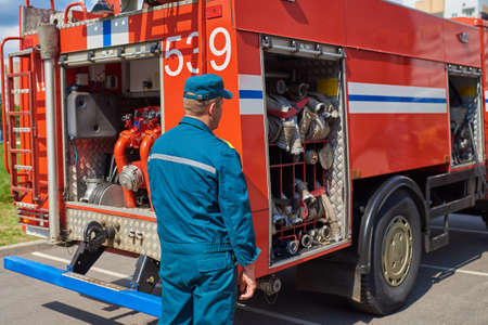 Man firefighter on the background of a fire truck for any purpose