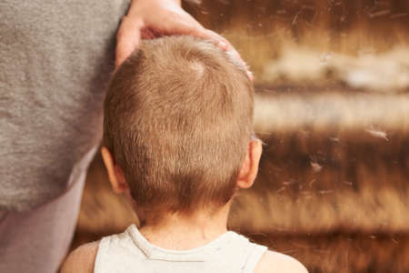 A man cuts machine child at home. For any purpose.の写真素材