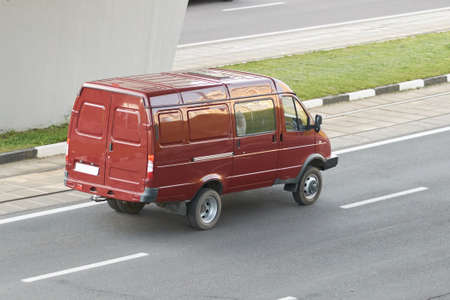 Red minibus in the city rear view for any purpose