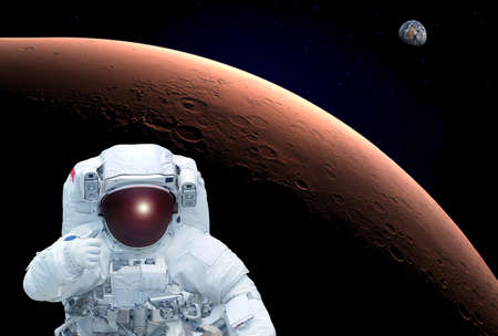 The astronaut in an orbit of Mars, shows the sign a class, Earth is in the distance visible....