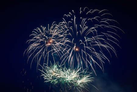 Big and small, beautiful sparkling volleys of festive salute, green, in the night sky for any...