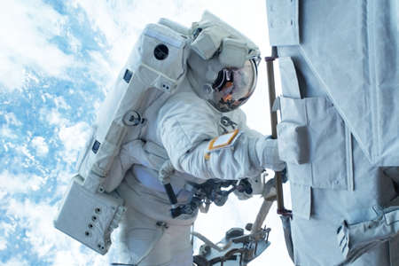 Astronaut in outer space is shooting the Earth. Elements of this image were furnished by NASA for...
