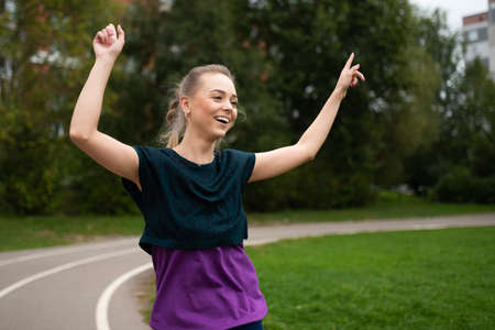 Athletic girl, on a treadmill, having fun and smiling. For any purpose