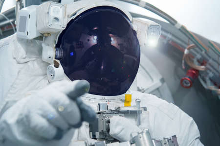 Astronaut in a spacesuit. Point finger forward. Elements of this image were furnished by NASA. Elements of this image were furnished by NASA. For any purpose.の写真素材