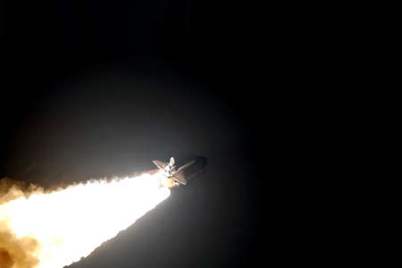 The launch of a space rocket at night, in a dark sky. Copy space Elements of this image were furnished by NASA. For any purpose.の写真素材