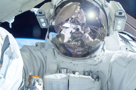 Astronaut in open space above the planet.