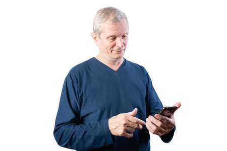 Elderly man with a smartphone. Isolated on a white background. For any purpose.の写真素材