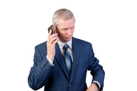 An elderly man in a suit talking on the phone. Isolated on a white background. For any purpose.